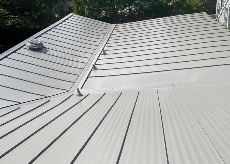 Solar attic fan installed on a metal roof for Roof Ventilation in Lakeland Village